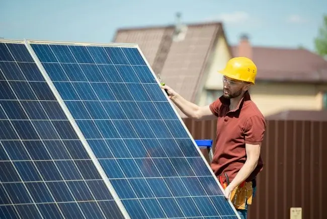 professional carrying a solar panel