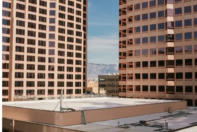 building with a flat roof system surrounded by other commercial properties