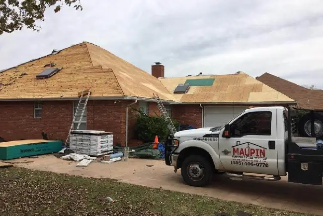 maupin roofing truck during a roof installation