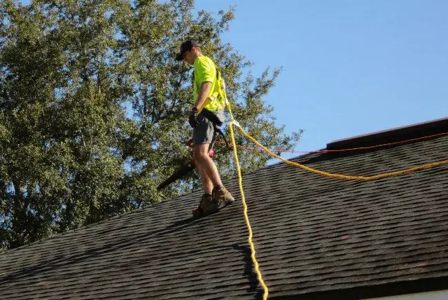 man doing roof inspection