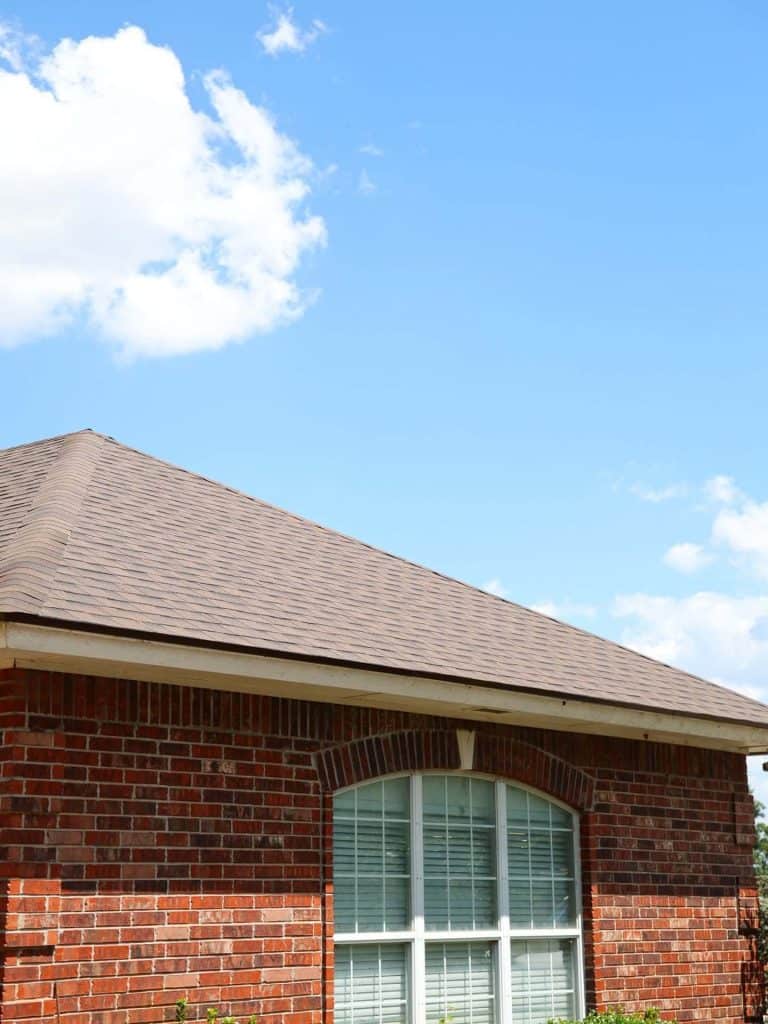 Hip roof new shingles brick home closeup, a Maupin Roofing & Construction job