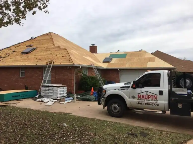 Maupin Roofing & Construction work truck parked at a home during a reroof