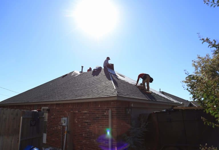 Roofers installing shingles hip roof, a Maupin Roofing & Construction job