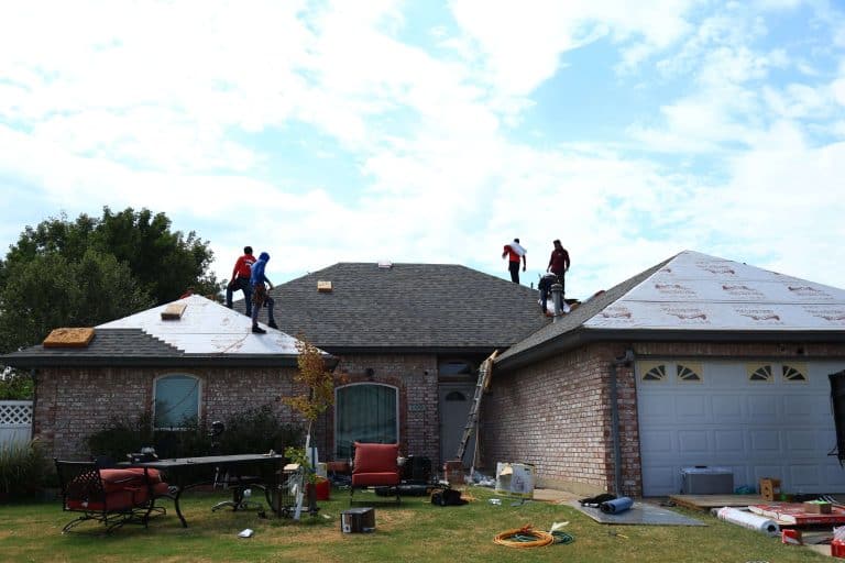 Roofing crew on roof during replacement, a Maupin Roofing & Construction job